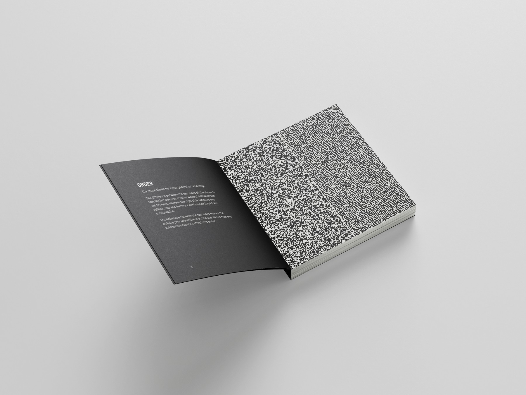 Open book with a dark text page beside a dense ornamental pattern